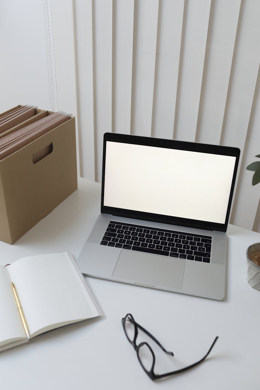 laptop and papers on table in office